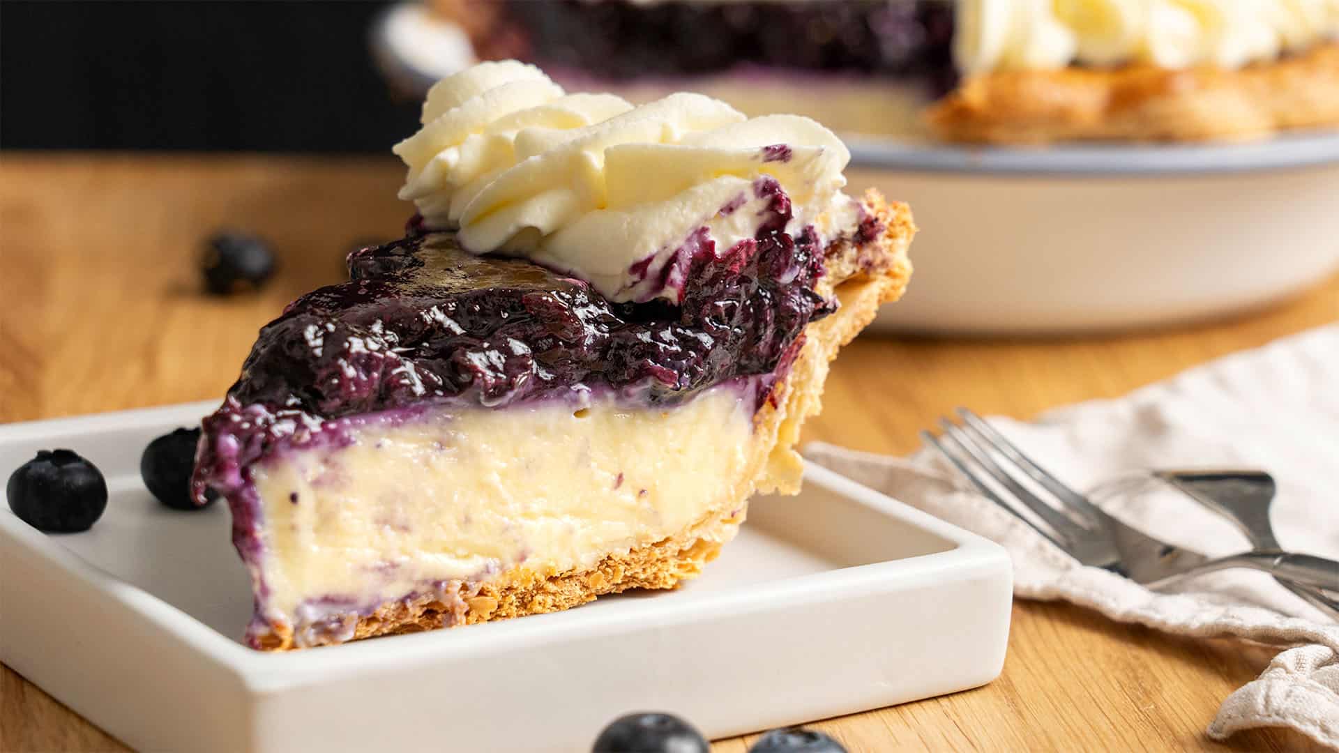 A slice of Blueberry Cream Pie on a plate.