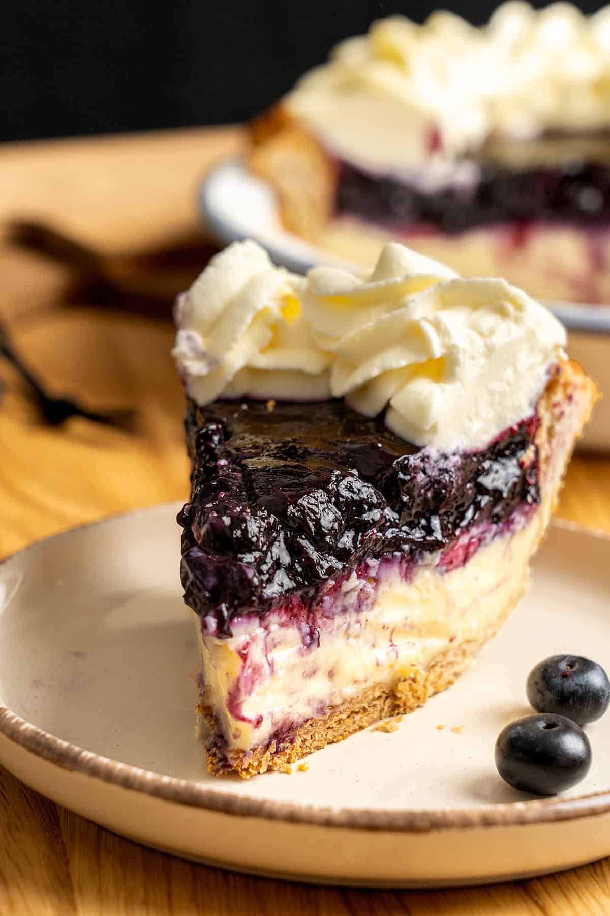 A slice of Blueberry Cream Pie on a plate.