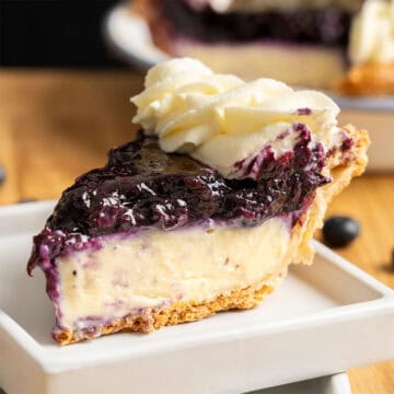 A slice of Blueberry Cream Pie on a plate.