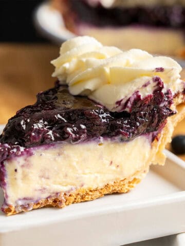 A slice of Blueberry Cream Pie on a plate.