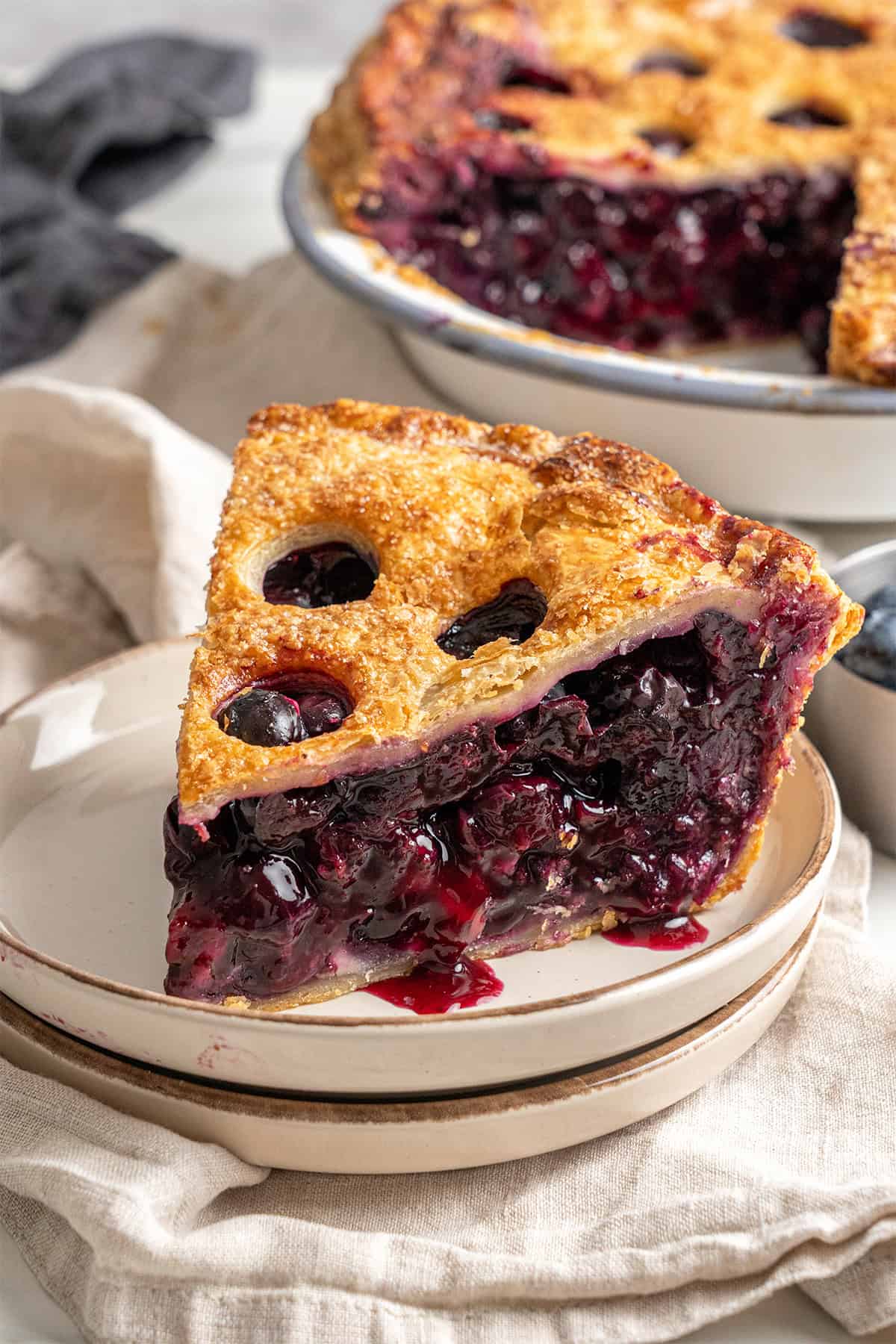 A slice of Blueberry Pie on a plate.