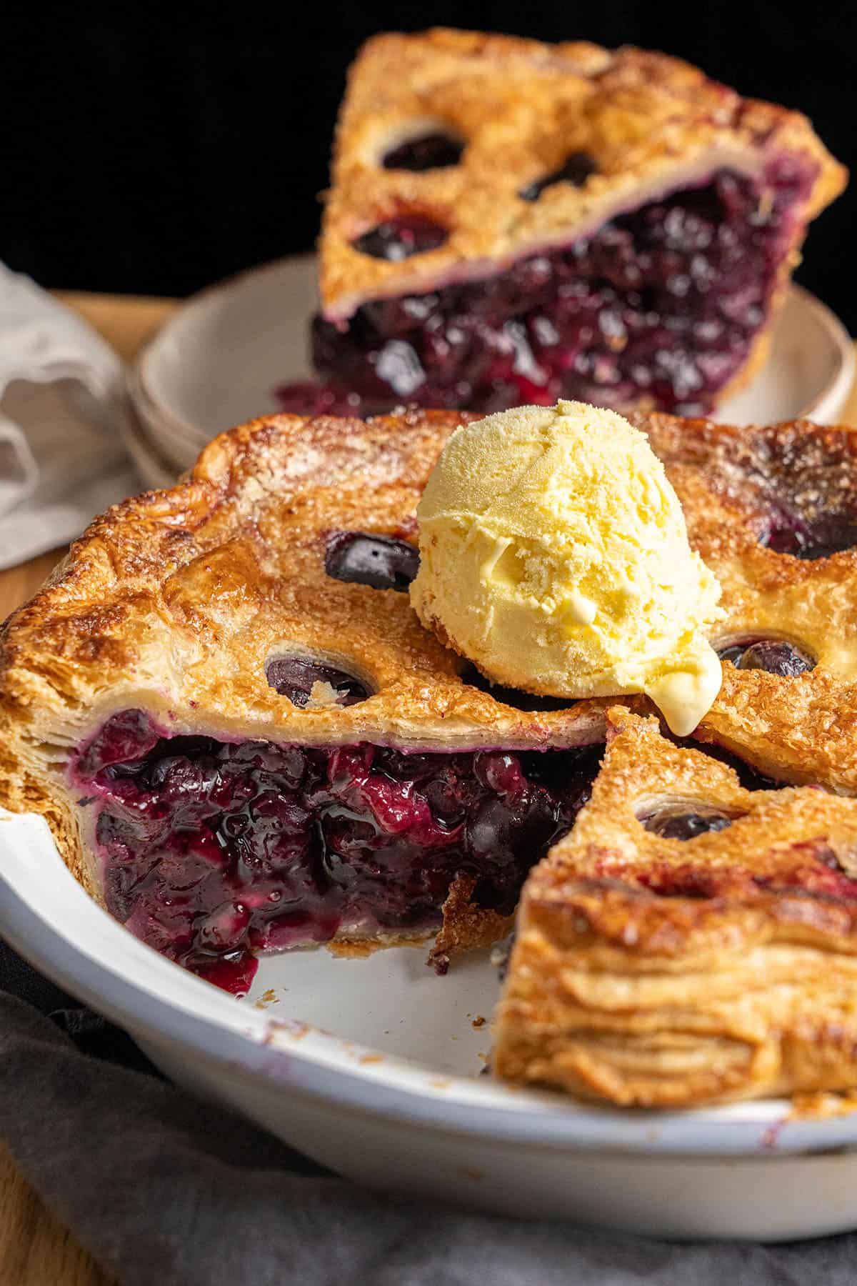 A slice of Blueberry Pie on a plate.