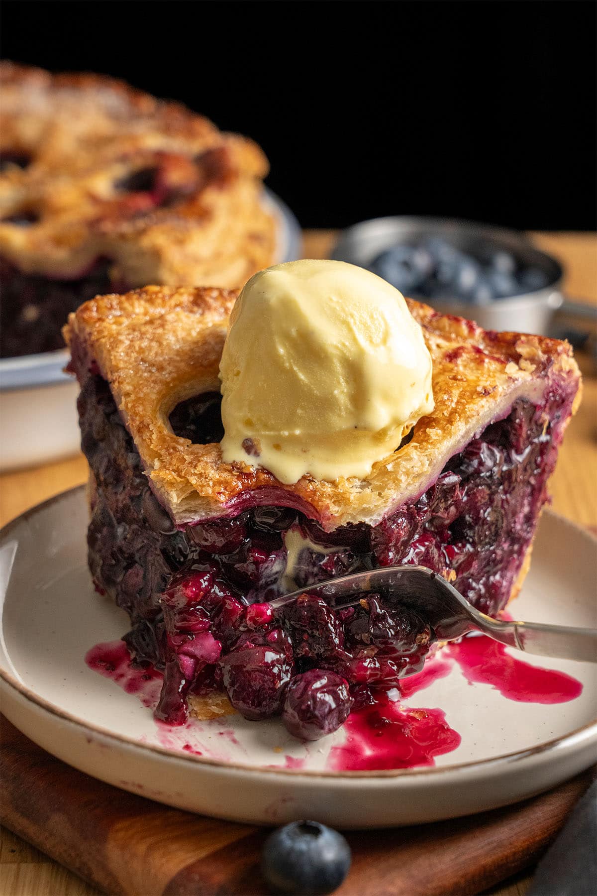 A slice of Blueberry Pie on a plate.