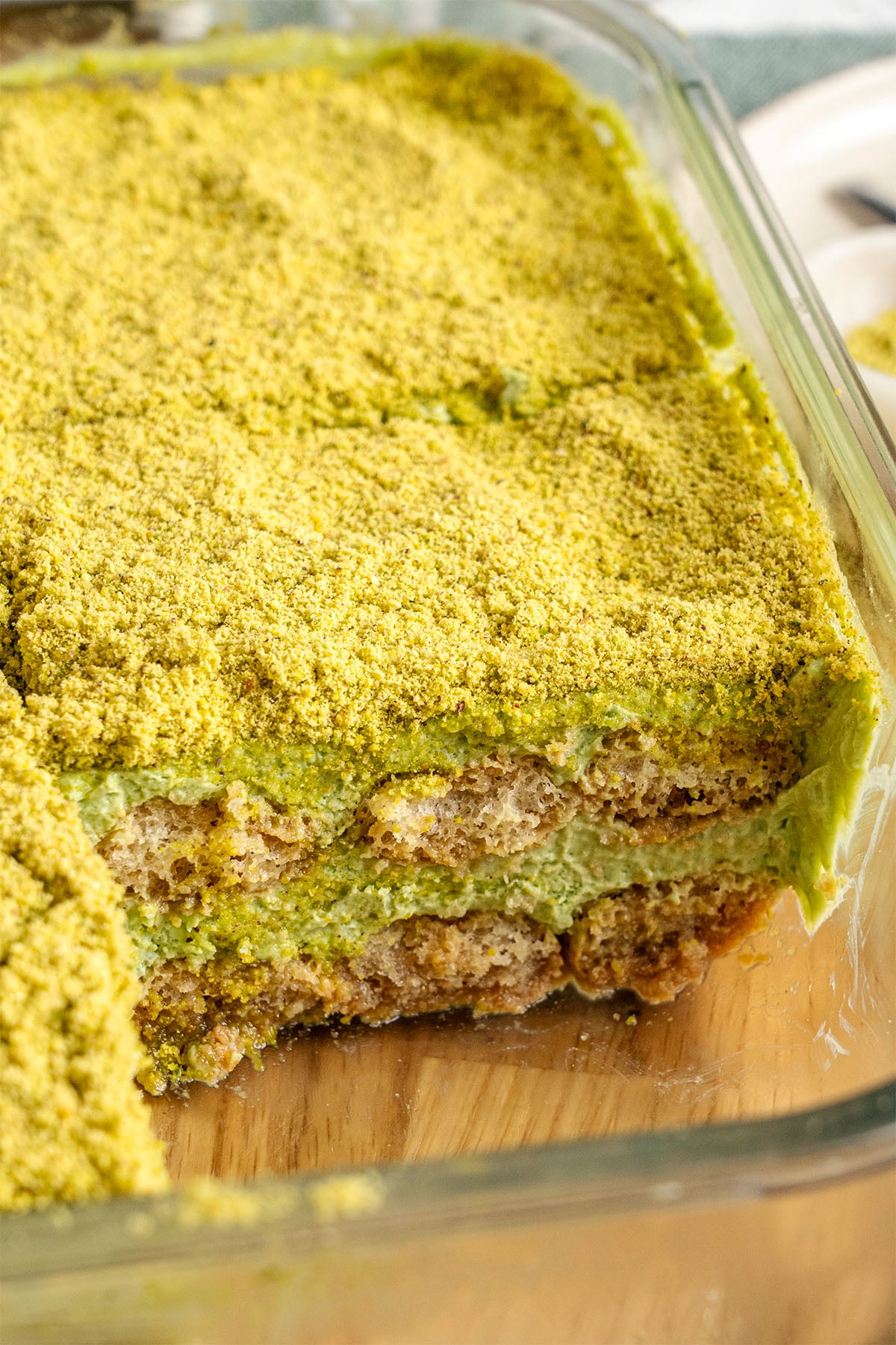 Pistachio tiramisu in a food container.