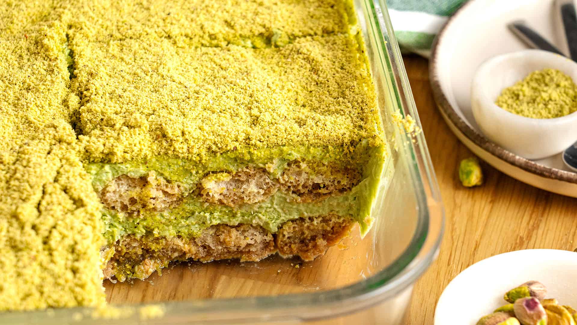 Pistachio tiramisu in a food container.