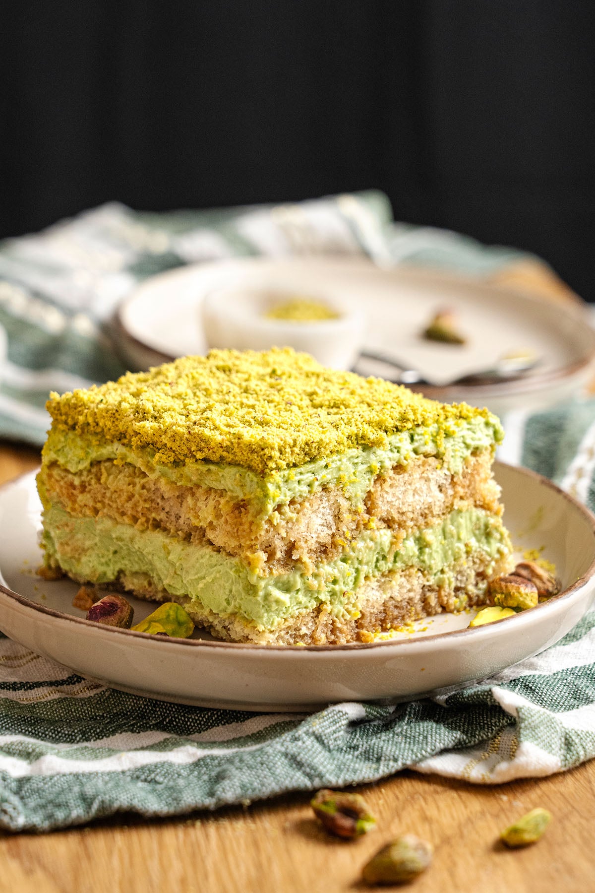 A slice of Pistachio tiramisu on a plate.