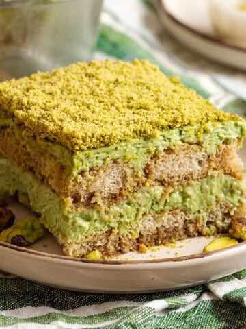A slice of Pistachio tiramisu on a plate.
